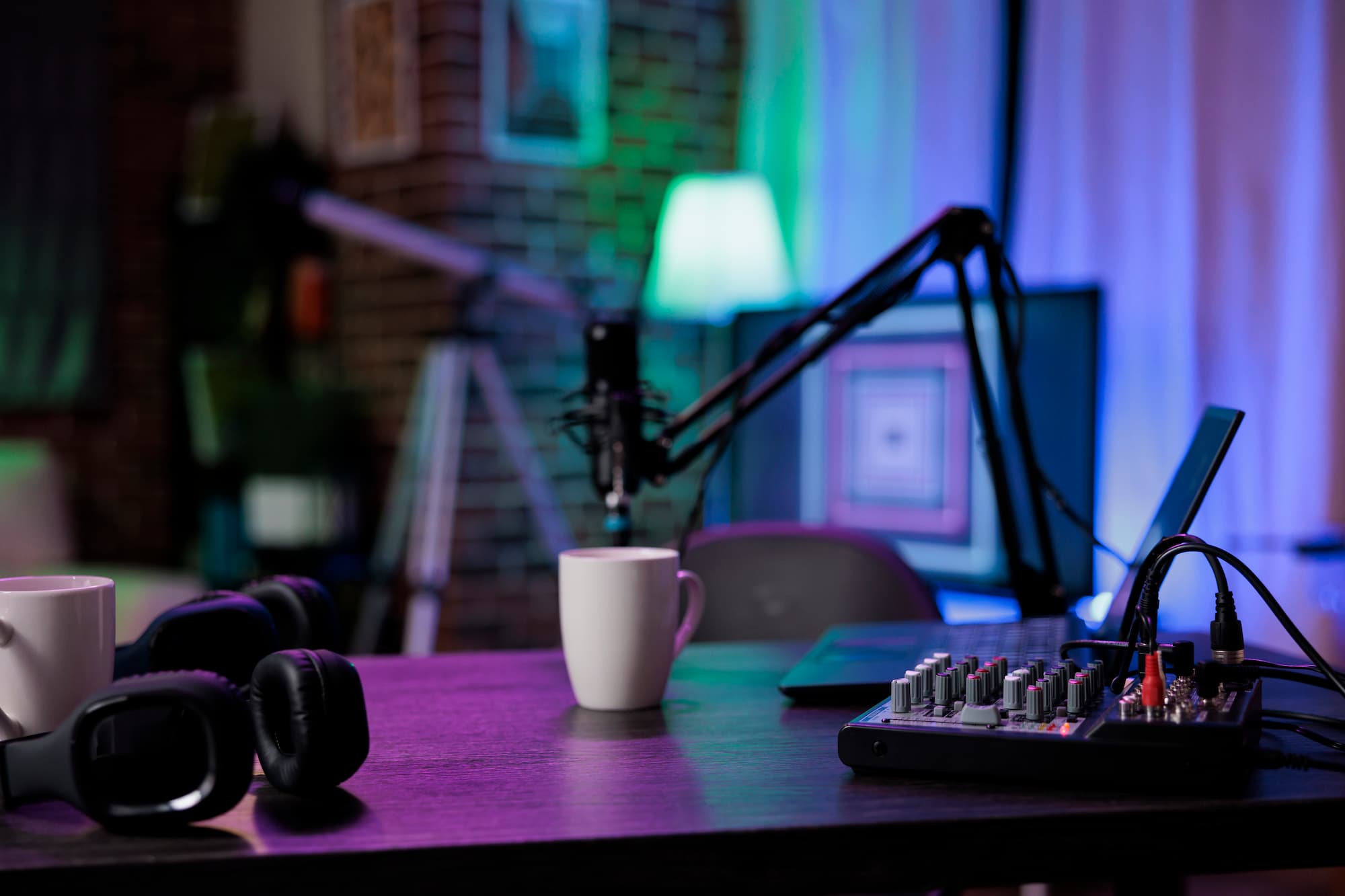 Microphones, headphones, and an audio mixer set up for podcast recording